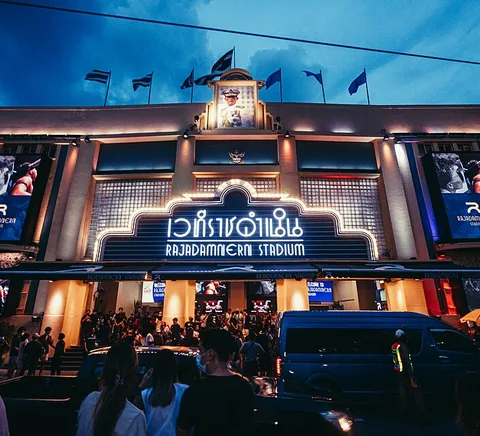 Illuminated entrance facade of Rajadamnern Stadium in Bangkok, photographed 1 July 2023.