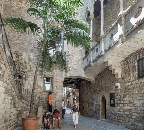 Historic courtyard within Barcelona’s Picasso Museum; stairway and visitors, no Picasso works reproduced.