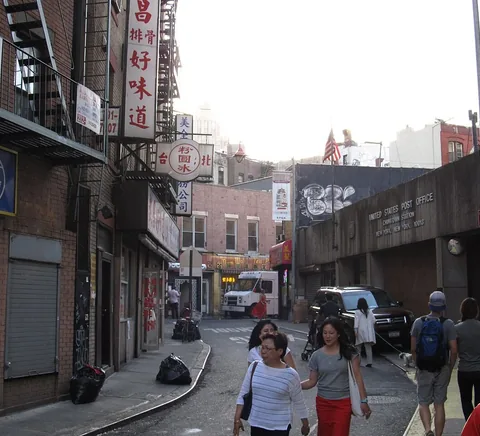 Doyers Street restaurant signs and walking pedestrians in Manhattan Chinatown, 2012.